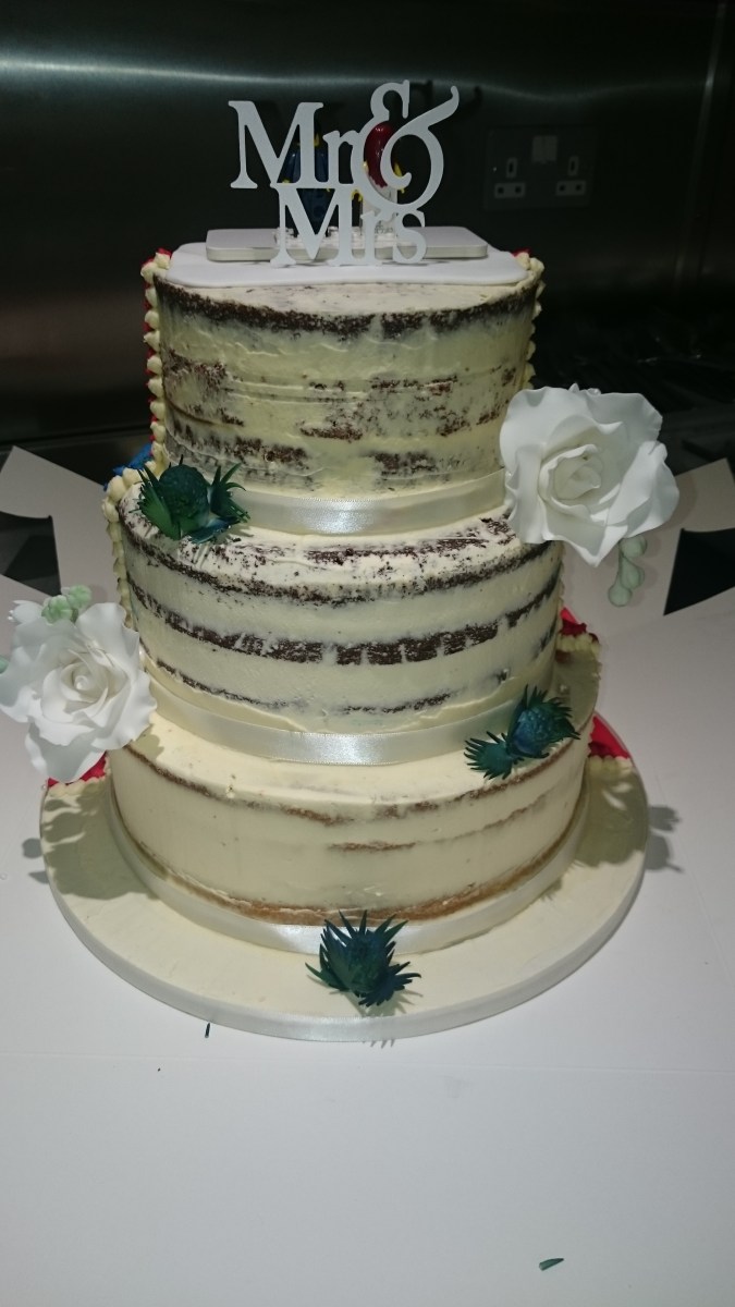 Semi-naked half and half wedding cake with handmade sugar flowers and superhero design